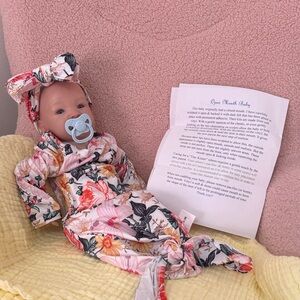 Floral Baby Doll with Pacifier and Headband. Cloth body weighing around 5lbs.
